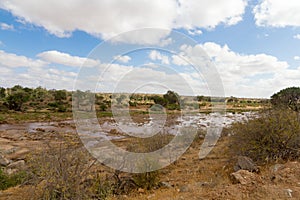 African Landscape of open savanna and river on sunny day, Tsavo