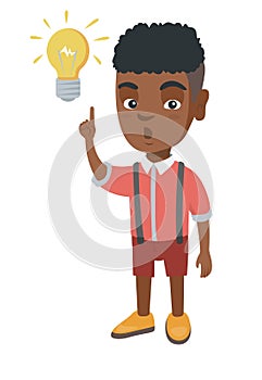African little boy pointing at the lightbulb.