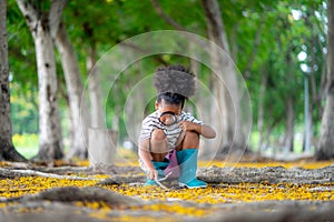 African little girl exploring in the woods and looking for insects, Child playing in the forest with magnifying glass. Curious kid photo