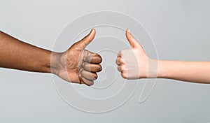 African male hand showing thumb up. Black and White hands showing Like together. Woman hands showing thumbs up. Black