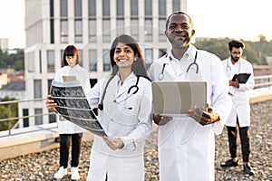 African male with laptop and young Indian female doctor with stethoscope