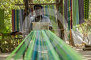 An african male performing traditional weaving in Gambia