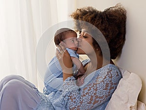 African Mama with baby hugging