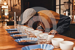 African man at a coffee tasting taking the aroma