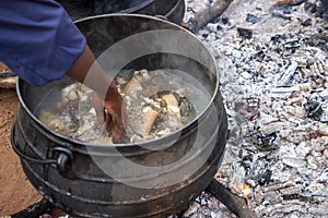 African man cooking outdoors