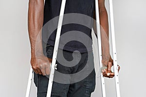 African man with crutch. Close-up. Side view