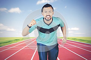 African man doing a sprint on the track