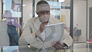African Man Doing Video Talk on Digital Tablet in Office