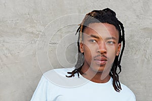 African man with dreadlocks glancing away