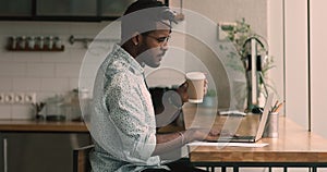 African man drink coffee keep business correspondence using computer