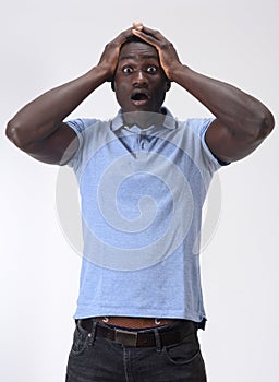 African man with expression of forgetfulness or surprise on white background photo