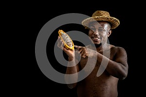 African man famer holding and showing  fresh cocoa photo