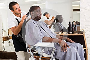 African man getting haircut