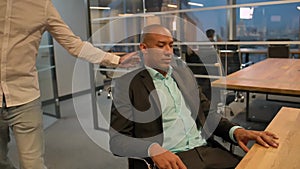 African man handshake caucasian colleague in business office with smile