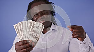 African man holding money in his hand and pointing on it with finger