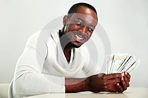 African man holding US dollars