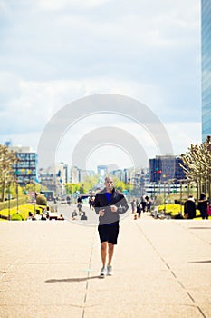 African Man Jogging In La Defense, Paris