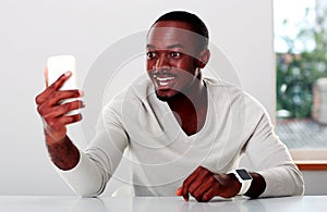 African man looking on smartphone