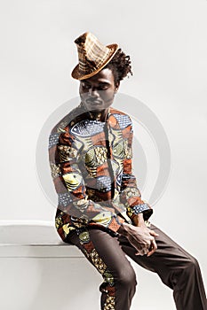 African man in national kongo costume sit on coub