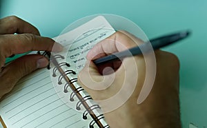 African man  pen in hand to write on  notebook.