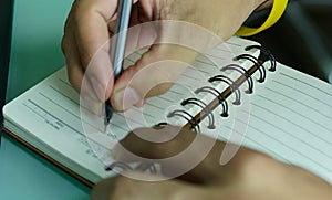 African man  pen in hand to write on  notebook.