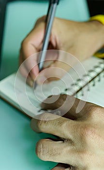 African man  pen in hand to write on  notebook.