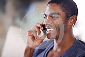 African man, phone call and home on sofa with smile for conversation, contact and listening in lounge. Person