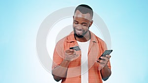 African man, phone and credit card in studio with smile on face, deal and easy payment by blue background. Trader guy