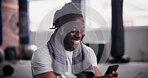 African man, phone and texting in gym with smile for notification, chat or web blog for training. Person, smartphone and