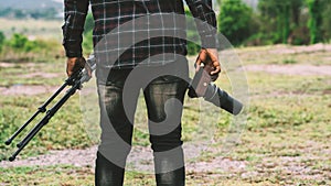 African man photograpy holding the camera and tripod photo
