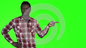 African man pointing on green