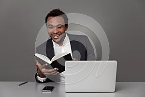 African man reading a book