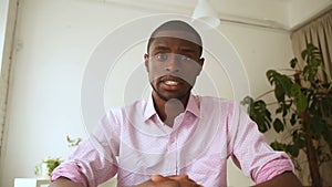 African man recording video message, talking on webcam at interview