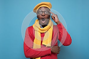 African man screaming in shock, keeping mouth wide open, feeling excited