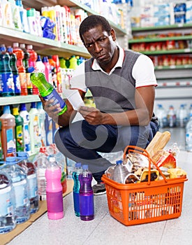 African man shopping with list