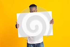 African man showing blank white big A2 paper