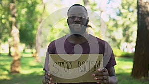 African man showing stop racism sign, national problem, equal rights, abuse