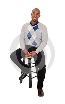 African man sitting on an chair smiling