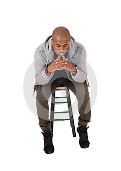 African man sitting and thinking about his life