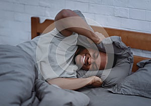 African Man Suffering From Headache And Insomnia Lying In Bed