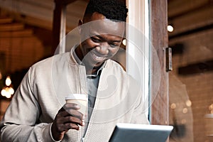 African man, tablet and reading in cafe with smile, drink and notification for networking, contact and email
