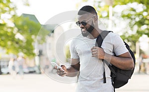 African man tourist searching sightseeings on cellphone