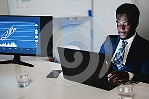 African man trader working inside hedge fund office - Focus on face