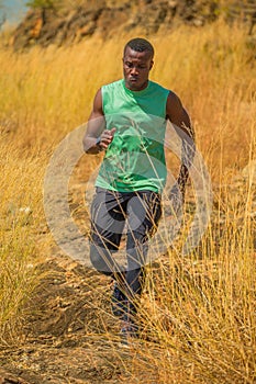 African man Trail running in Meadow on mountain outdoor. sport adventure . black man runner  jogging on country path or cross-