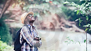 African man traveler smile and relax in jungle.Survival travel concept