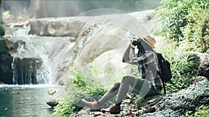 African man traveler take photo at the waterfall.16:9 style