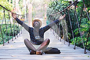 African man traveller sitting on the bridge