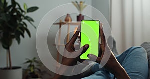 African man typing message on mock up screen with trecking markers . Guy using smartphone and chatting in social