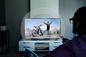 African Man Watching TV Movie In Glasses