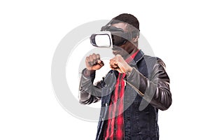 African man wearing formal suit and virtual reality headset or 3d glasses, playing video game, gesturing with his hands and catchi